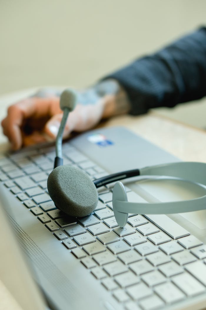 Close-up of a headset on a laptop keyboard, representing remote work and customer support.